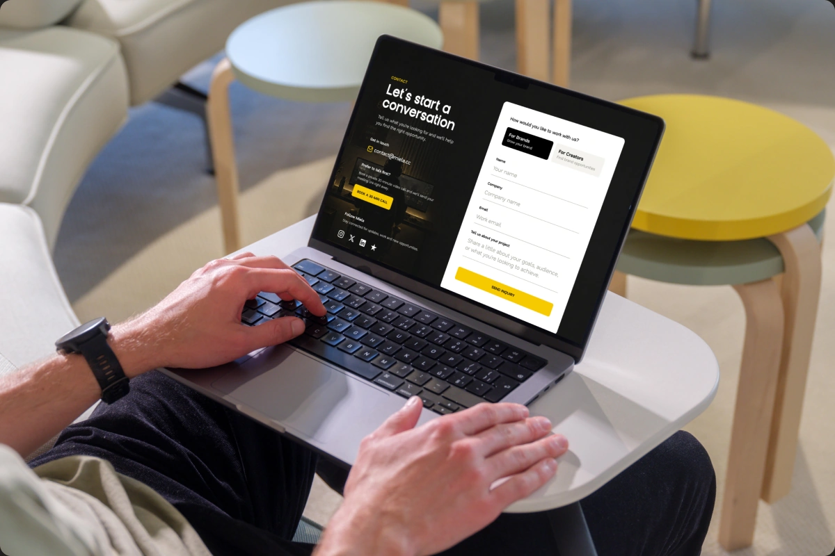 Miela website displayed on a laptop in a casual workspace